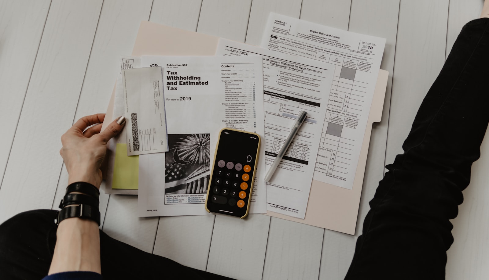 A calculator and financial charts on a desk, representing AI pricing math